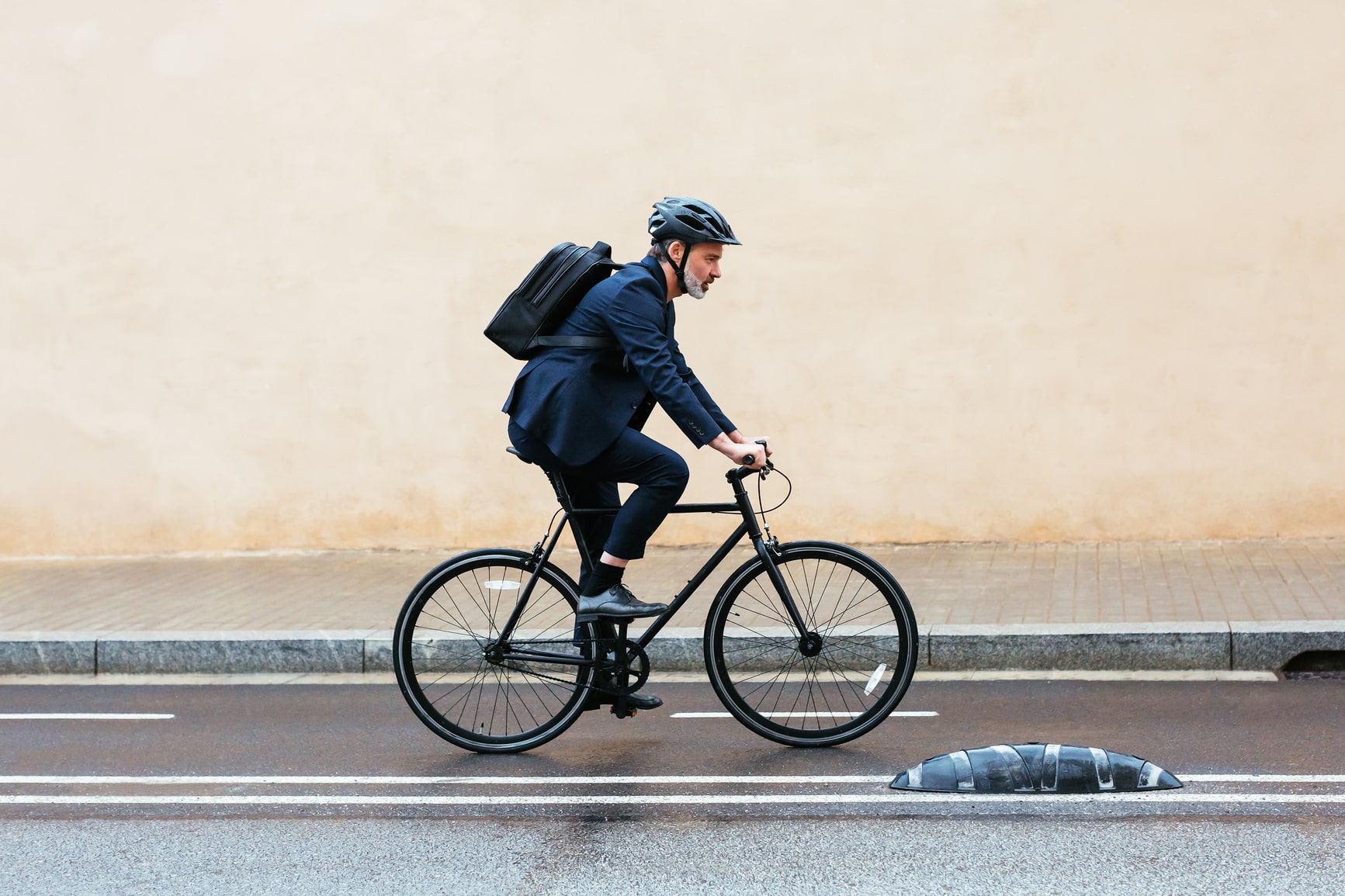 Grey-haired-businessman-riding-a-bike-to-work (1)-min